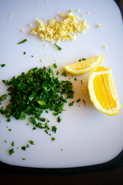 lemon and parsley on cutting board