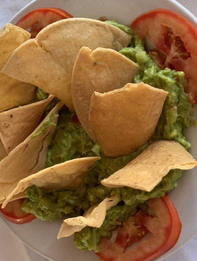 guacamole on a plate with chips